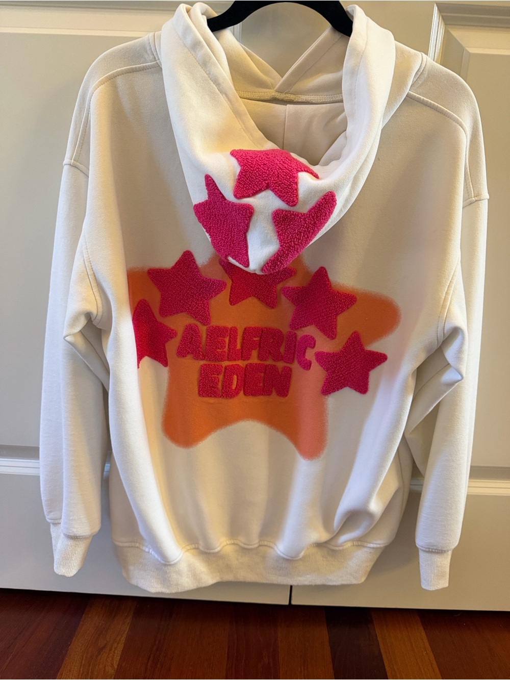 Aelfric Eden White Hoodie with Orange Back Graphic & Pink Chenille Stars